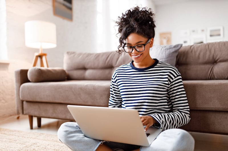 young-woman-on-laptop-on-floor_409339746