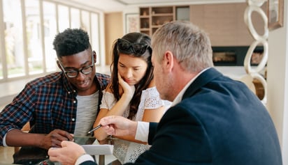 couple discussing mortgage terms with a mortgage broker