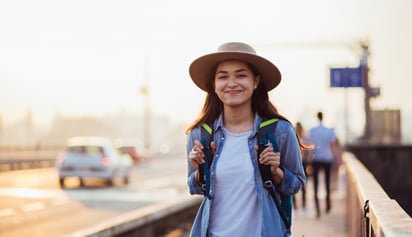 woman wearing a hat and backpack