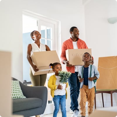 family moving in with boxes in their hands