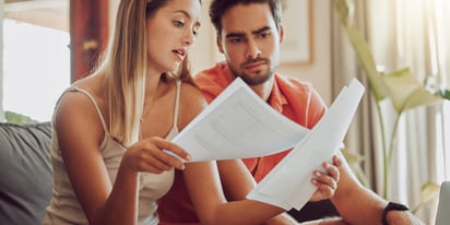 couple reviewing bills on the couch