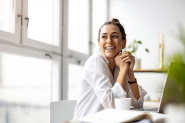 girl smiling with laptop and coffee