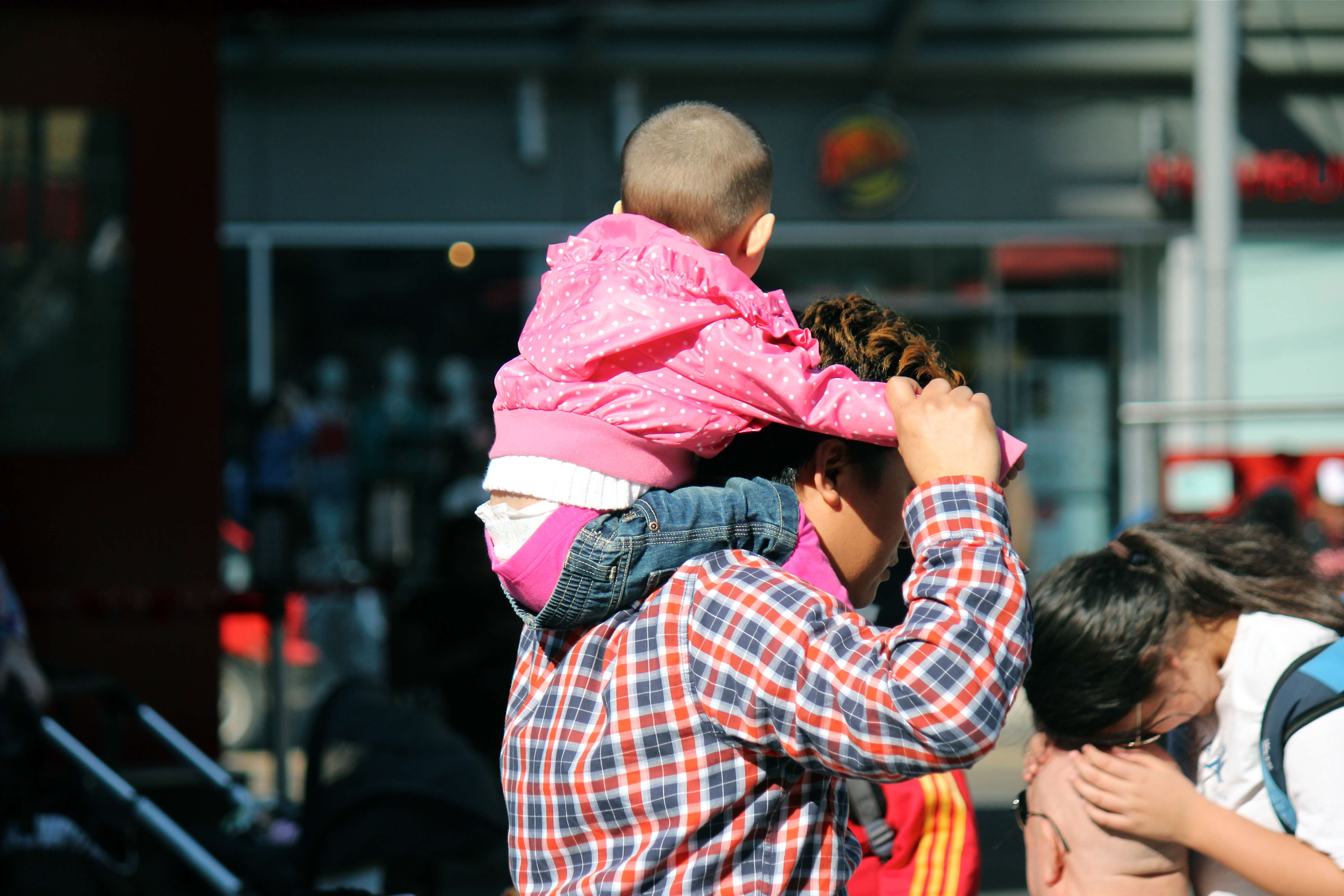 person with child on shoulders