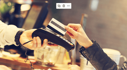 Close up of hand holding payment machine someone swiping their credit card