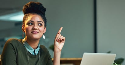 woman smiling and pointing up
