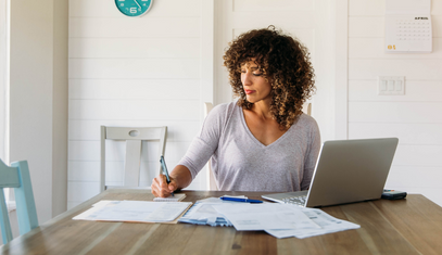 woman doing her finances and paying rent and debt