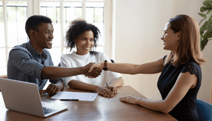 couple shaking hands with their mortgage broker