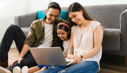 family looking at a laptop