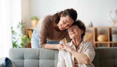 a mother and her daughter smiling and hugging