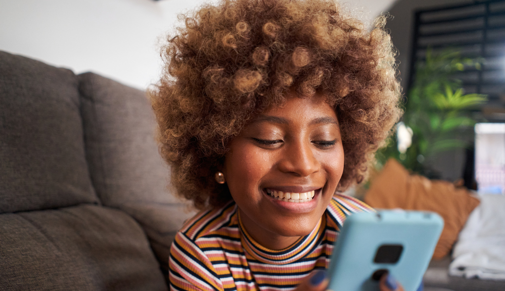 woman using AI on her phone and smiling