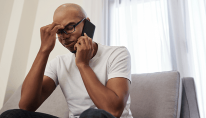 man talking on the phone looking stressed