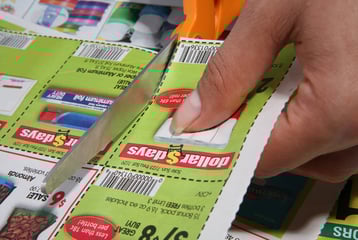Person cutting coupons