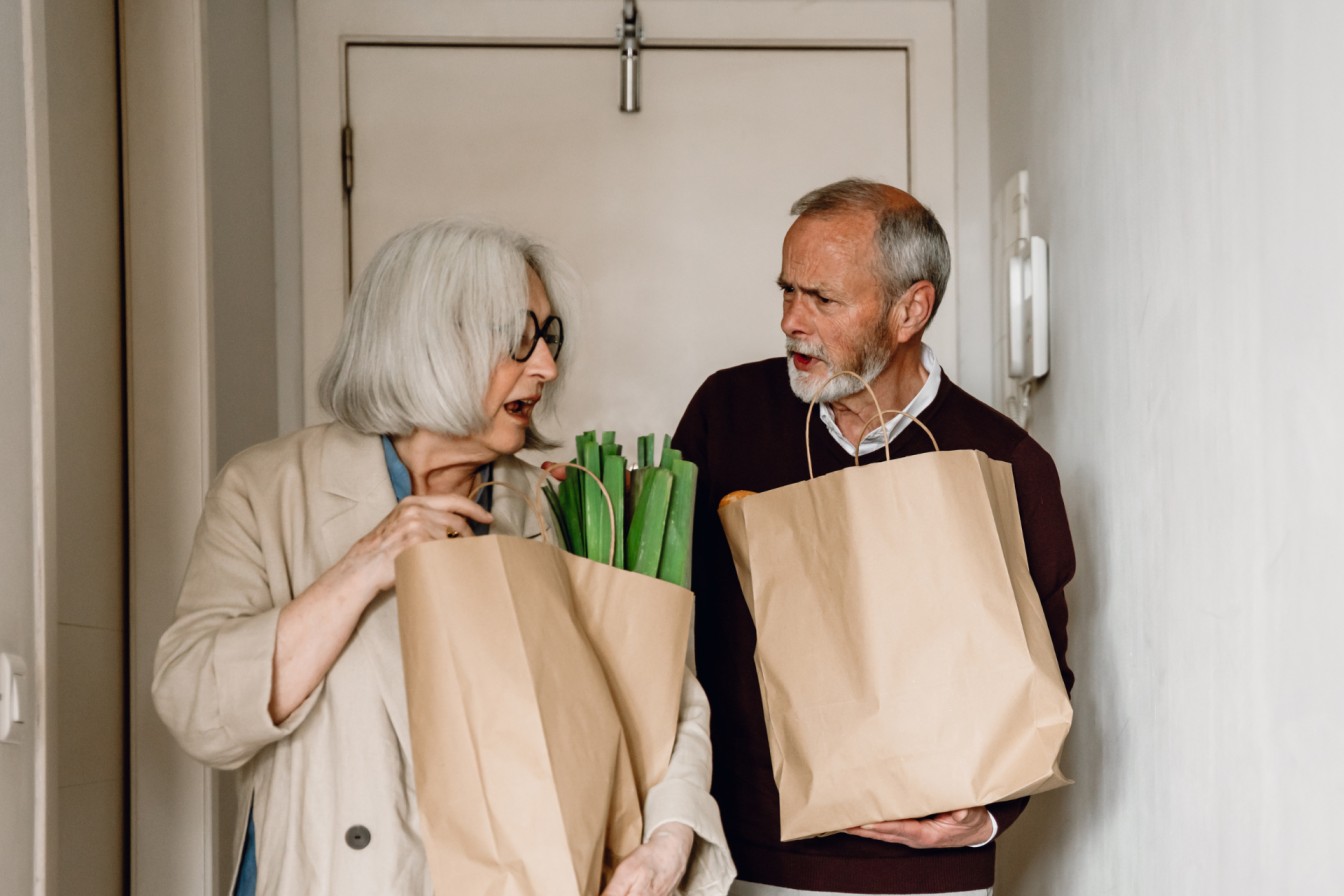 man and woman with grocery bags