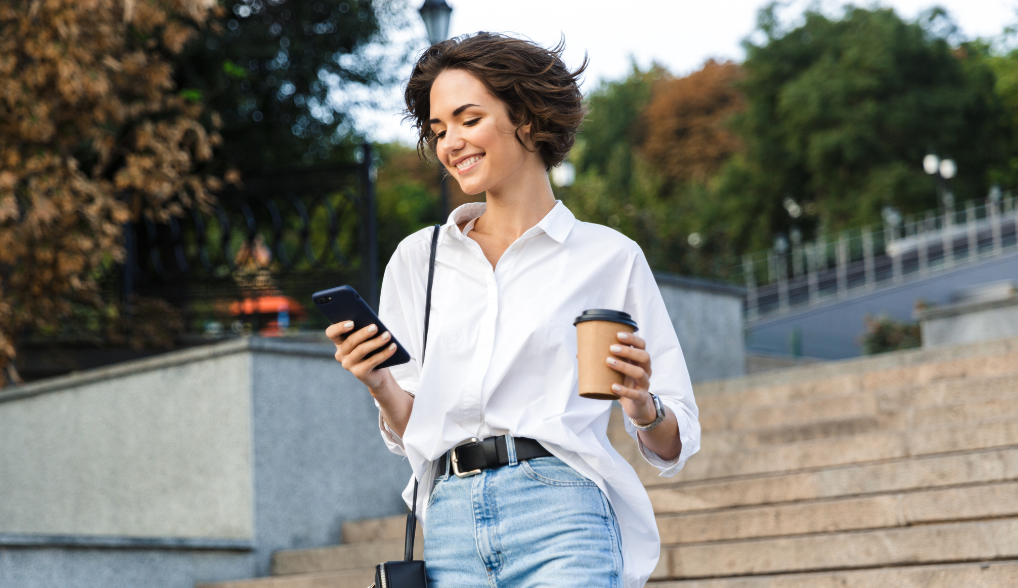 woman walking with a cup of coffee