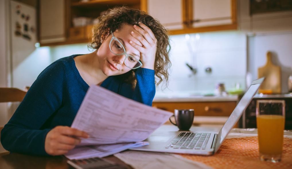 woman filing her taxes and looking stressed