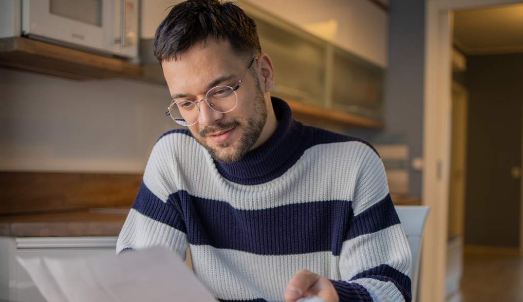 man wearing glasses doing his taxes
